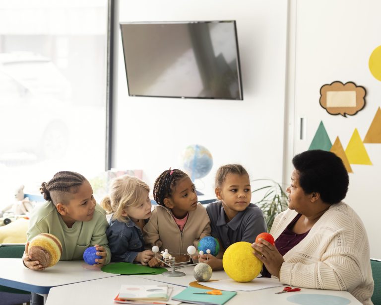 woman-teaching-kids-about-planets